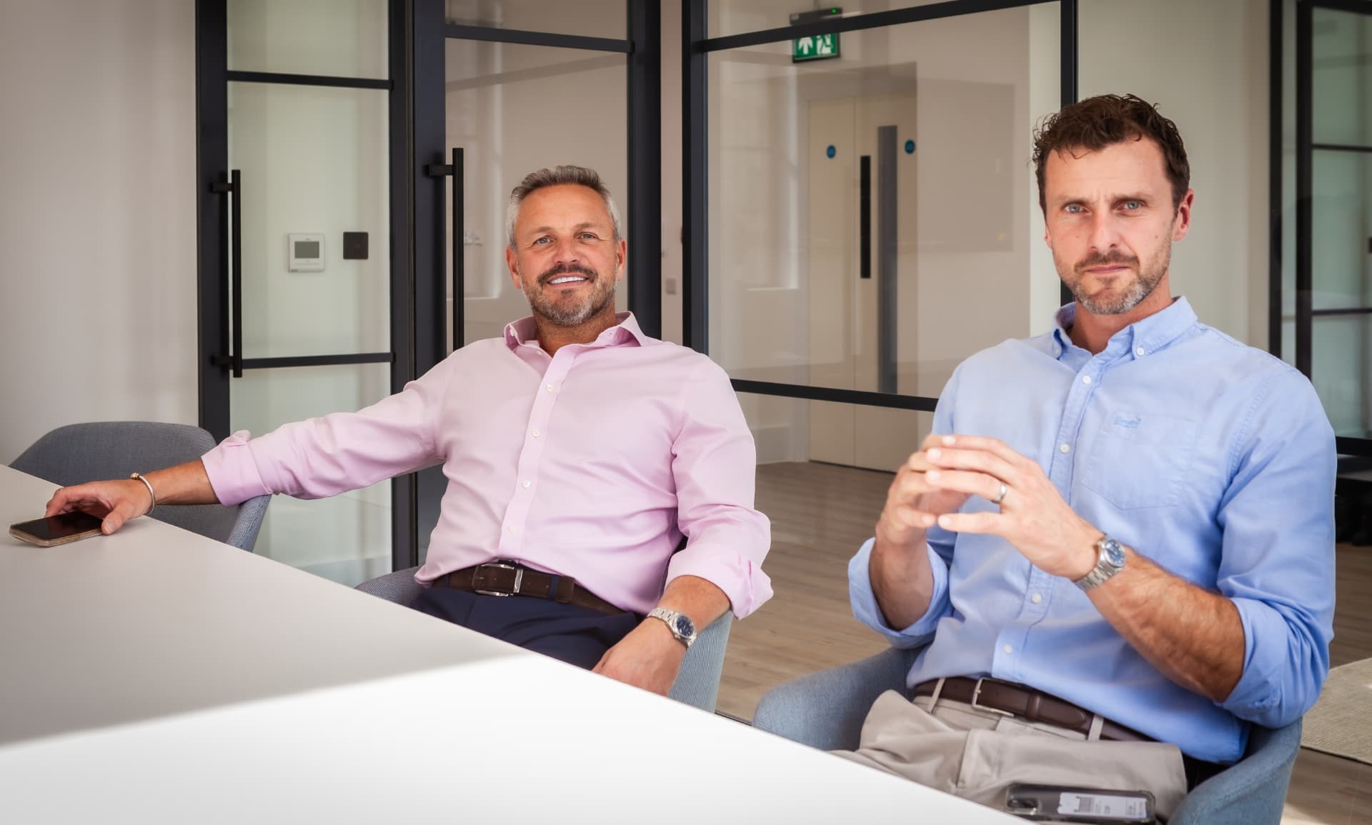 Property Investment Club — founders seated at the boardroom table