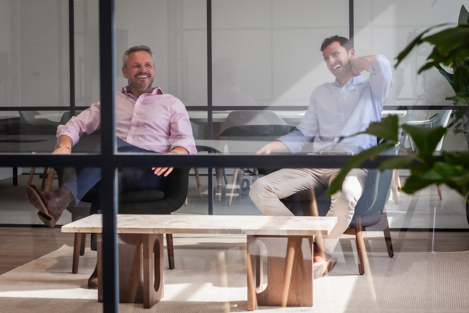 Property Investment Club — candid moment shot through glass partition