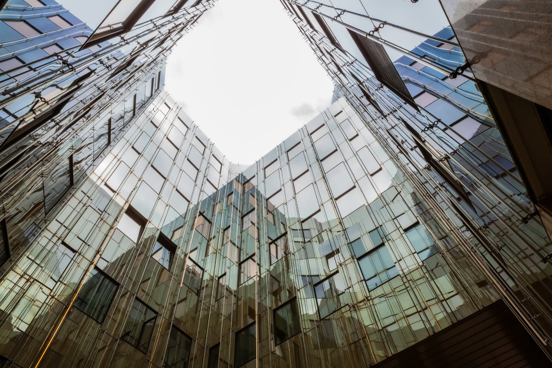 CLS Flexion — looking up at the mirrored glass facade of the Flexion building, Berlin