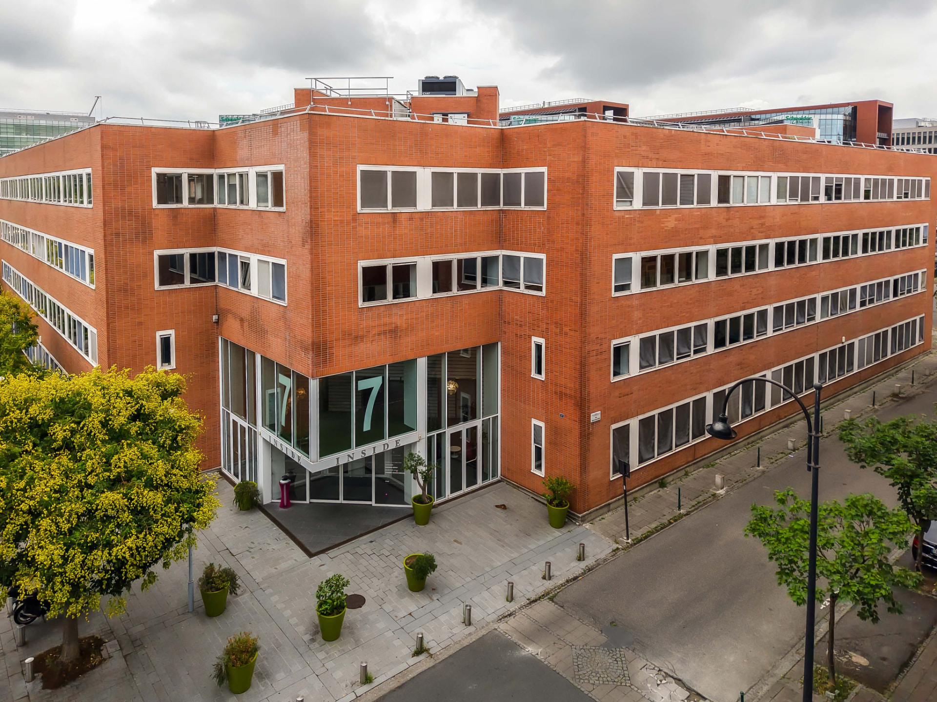 CLS Inside — aerial view of the red brick Inside 7 office building and paved plaza in Paris